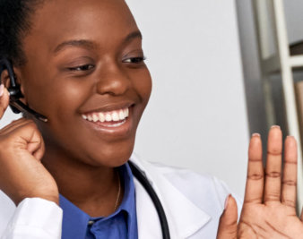 doctor smiling while holding a brocoli