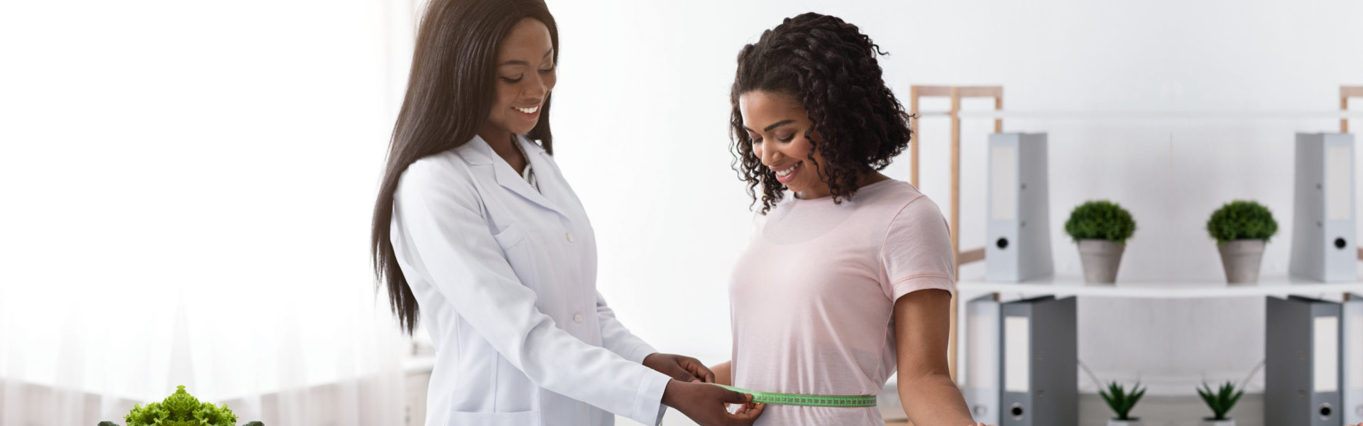 doctor measuring hips of the woman